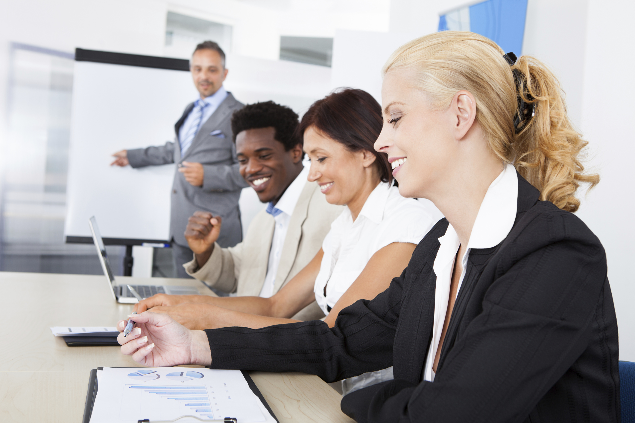 Business executives taking notes during a meeting